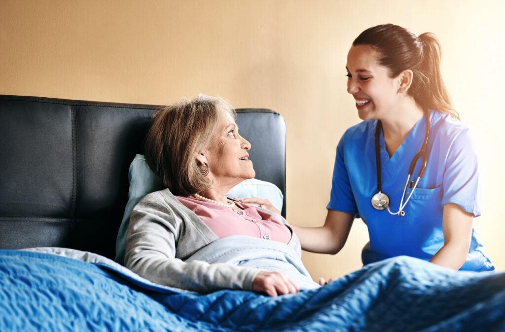 A caregiver smiling with an older woman